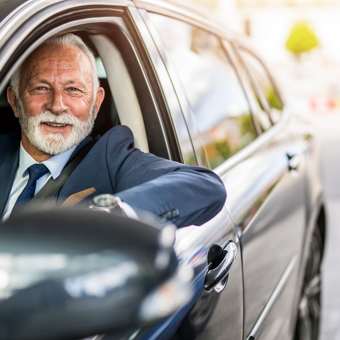 senior businessman driving a car.